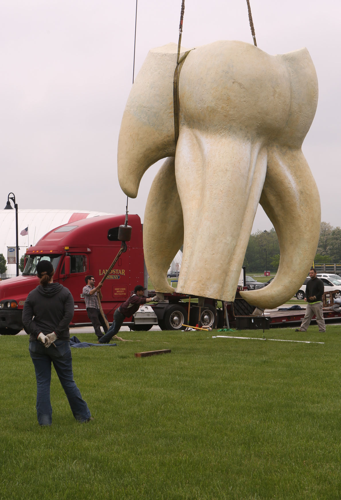 Artist Seward Johnson's "The Tooth" is implanted at the Crown Point Sportsplex